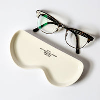 Eyeglasses on a white case with a white background